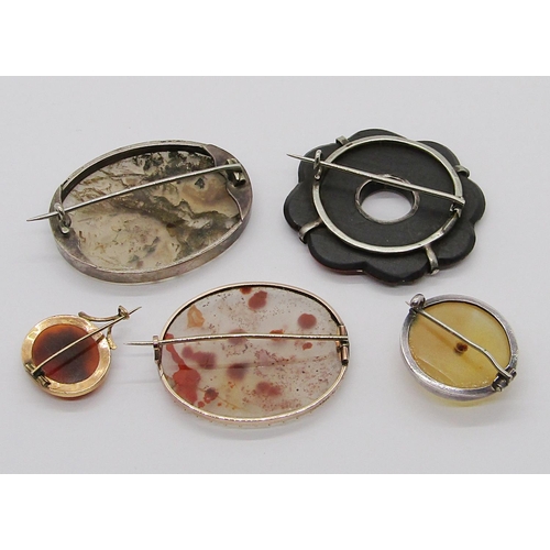 359 - Five antique brooches of various design all set with polished agate; two yellow metal and three whit... 