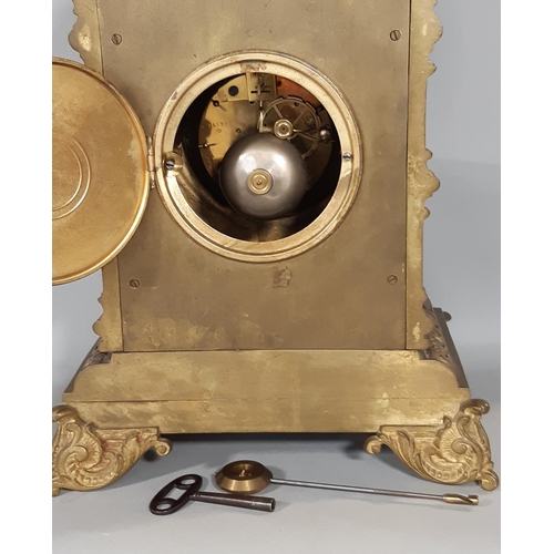 402 - A substantial Victorian mantel clock in a cast brass case detailing mask, scroll and repeating geome... 