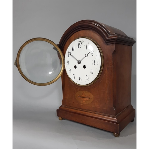 404 - An inlaid Edwardian mahogany mantel clock with string inlay and other detail, with enamelled convex ... 