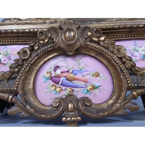 413 - A Victorian gilt brass mantel clock enclosing French porcelain panels, probably by Sevres, with enam... 