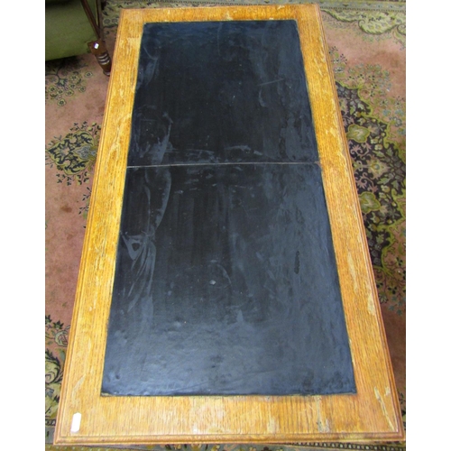 1533 - An oak pedestal desk of nine graduated drawers with brass plate handles and inset top, 110cm wide