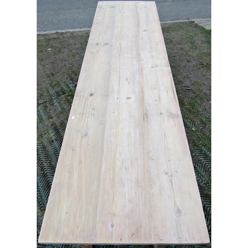 1537 - A stripped pine refectory table, the planked top raised on four square tapered supports, to seat eig... 