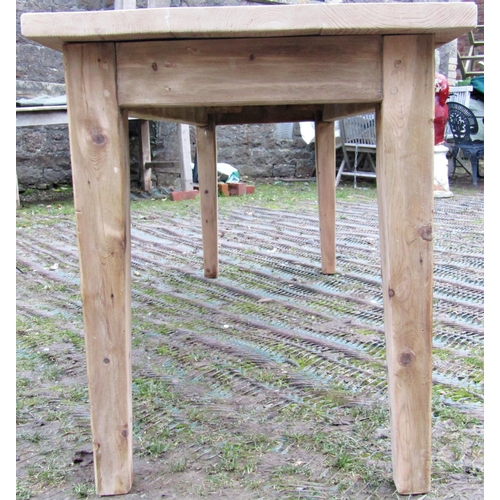 1537 - A stripped pine refectory table, the planked top raised on four square tapered supports, to seat eig... 