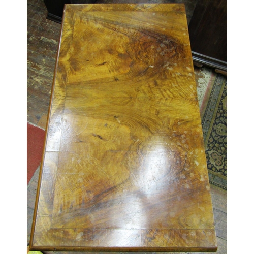 1543 - A walnut veneered chest of four long graduated drawers, the top with crossbanded detail raised on bu... 