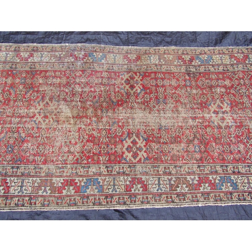 1471 - An antique Persian runner with a worn and faded geometric pattern, 400 x 108cm
