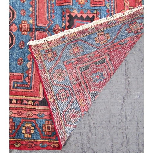 1475 - A Malayer rug with a central square medallion within running borders in shades of red and blue, 205 ... 