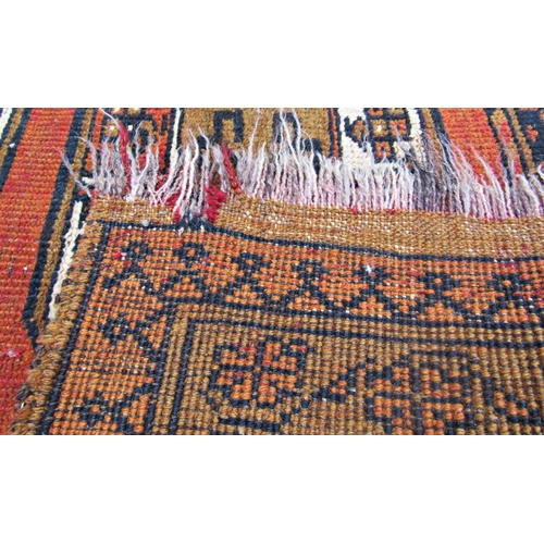 1479 - A middle eastern rug with a central row of four medallions upon a rust red ground, 150 x 100cm