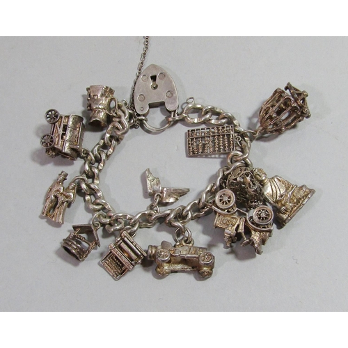 368 - Silver curb link charm bracelet hung with a selection of charms to include a Toby jug, bride and gro... 