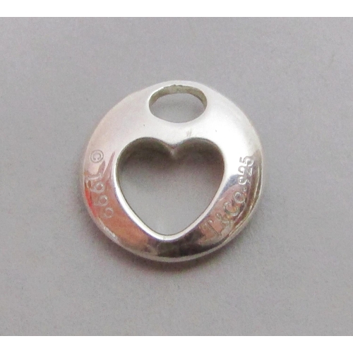 370 - Group of silver comprising a heart shaped pendant or charm stamped '© 1999 T&Co. 925', a silver scal... 