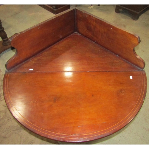 2167 - A 19th century mahogany oval drop leaf corner table with raised and shaped back raised on four cut a... 