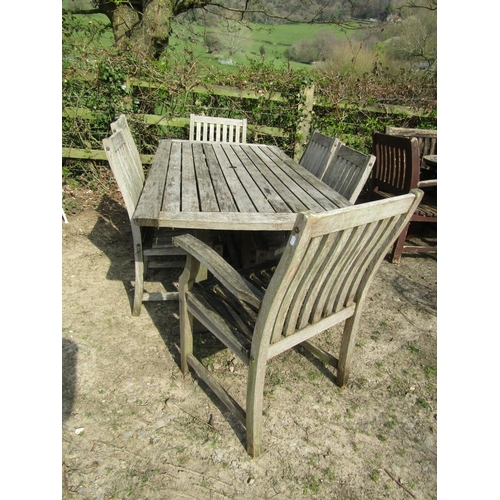 41 - Weathered teak garden table, the rectangular slatted top with curved ends raised on square cut and c... 