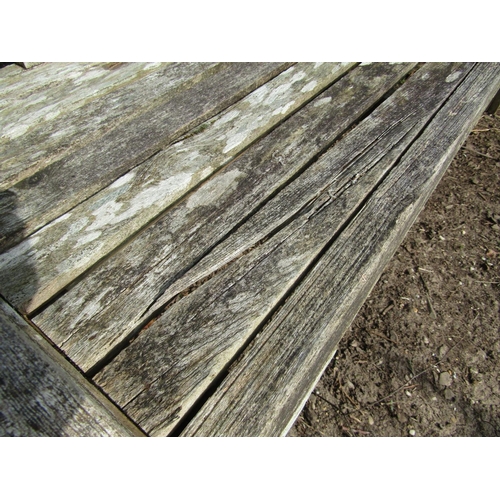 47 - An unusual, weathered teak garden bench with slatted seat, back and arched arms, with later table to... 