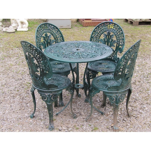 62 - A green painted cast aluminium garden terrace table of circular form, together with a set of four as... 