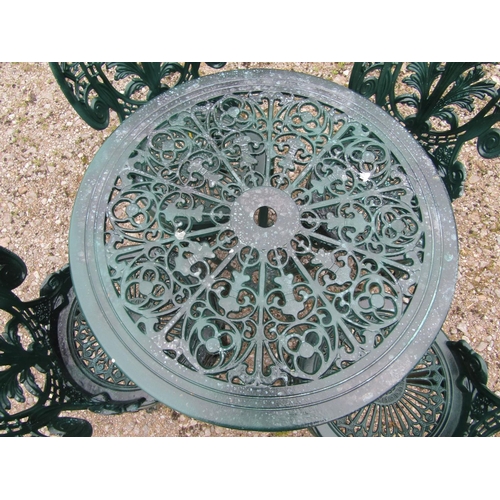 62 - A green painted cast aluminium garden terrace table of circular form, together with a set of four as... 