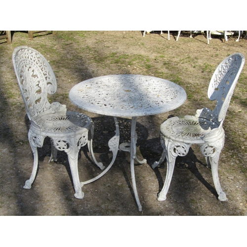 20 - Weathered cream painted cast aluminium three piece garden terrace set, comprising circular top table... 