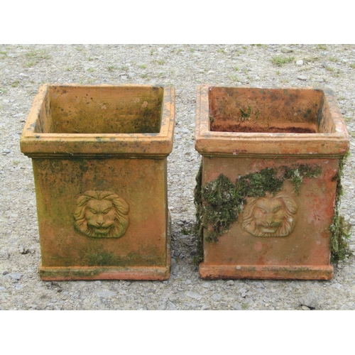 64 - A pair of weathered terracotta planters of square cut form with lion's mask detail, 32cm square x 35... 