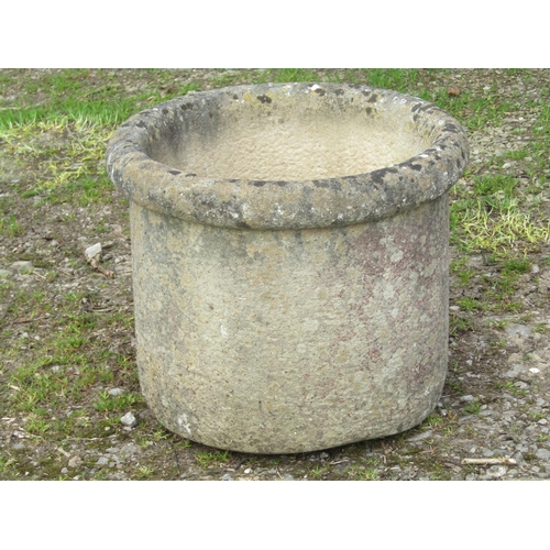 68 - A weathered composition stone cylindrical garden planter with moulded rim, stamped to interior Sandf... 