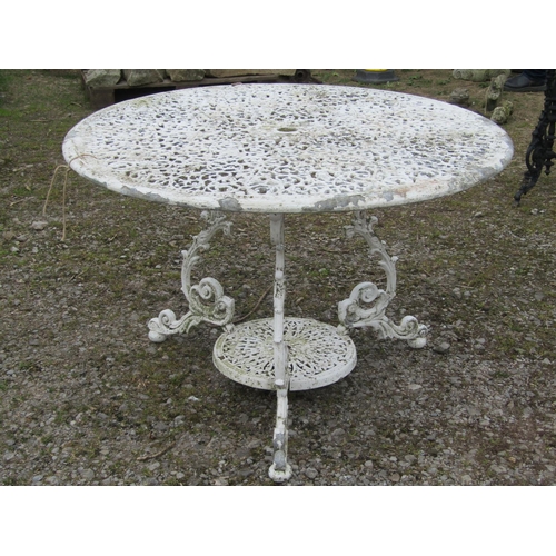 71 - A cream painted cast aluminium two tier garden terrace table of circular form, with decorative pierc... 