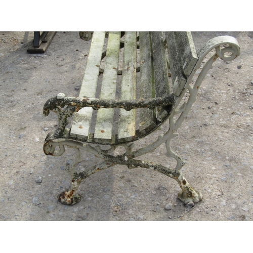 315 - A Victorian two seat garden bench with timber lathes raised on a pair of heavy gauge cast iron natur... 