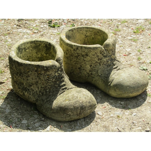 314 - A pair of novelty cast composition stone garden planters in the form of old boots, 50 cm long x 22 c... 