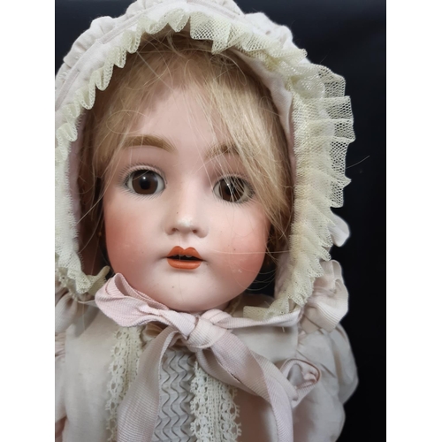 44 - An early 20th Century bisque head doll by Kammer and Reinhardt, with jointed composition body, sleep... 