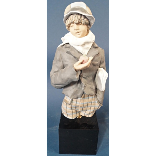 1009 - A Lladro half length figure of a boy wearing a cap and grey coat with an apple in his hand set on a ... 