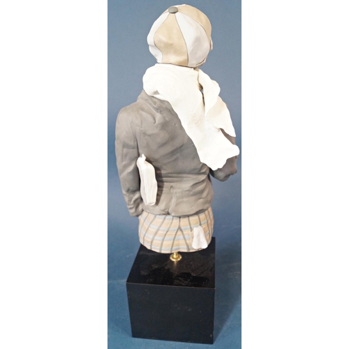 1009 - A Lladro half length figure of a boy wearing a cap and grey coat with an apple in his hand set on a ... 