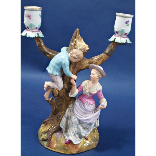 1067 - A pair of 18th century continental porcelain candlesticks with male and female characters each with ... 