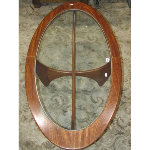 2076 - A G Plan oval occasional table with clear glass top raised on four swept support