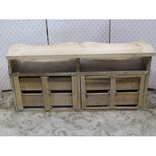 2101 - A rustic pine nest of eight short drawers, with shaped loose shelf/wooden back plinth, 103 cm wide a... 