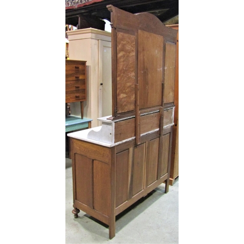 2102 - An oak buffet enclosed by a pair of panelled doors and two frieze drawers with marble top the raised... 