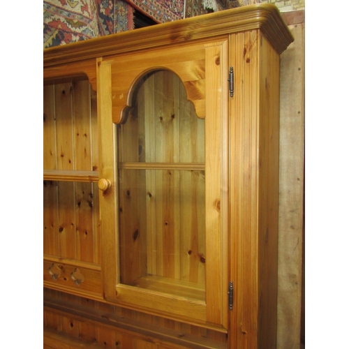 2119 - A pine dresser the base fitted with four panelled doors and four frieze drawers, the plate rack part... 