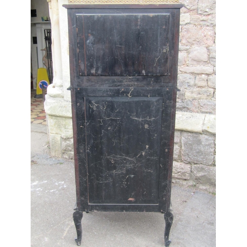 2125 - An Edwardian ebonised cabinet the lower section partially glazed, the upper section with serpentine ... 