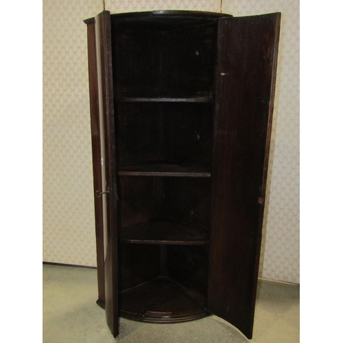 2148 - A Georgian mahogany bow fronted hanging corner cupboard of narrow proportions 115 cm high x 60 cm wi... 