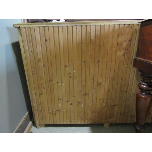 2154 - A stripped pine side cupboard enclosed by two panelled doors, 130 cm wide x 84 cm high