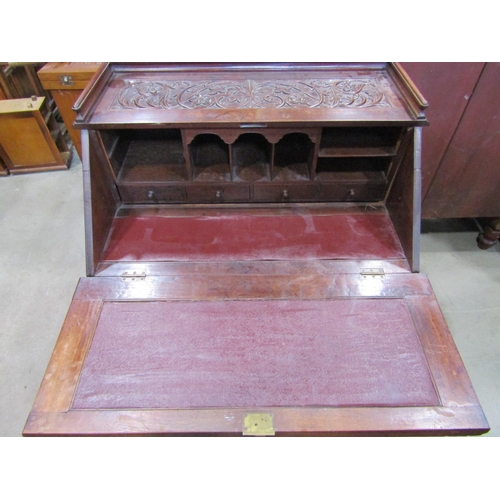 2158 - A Victorian bureau of three long drawers, the fall flap enclosing a simply fitted interior, the over... 