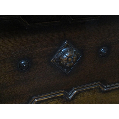 2163 - A late Edwardian oak sideboard in the Jacobean style, the two central drawers flanked by cupboards w... 