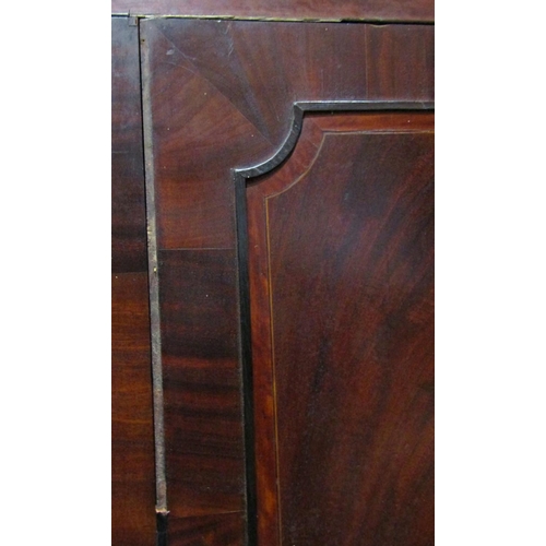 2172 - A Georgian mahogany linen press, the upper section enclosed by  a pair of well matched flame veneere... 