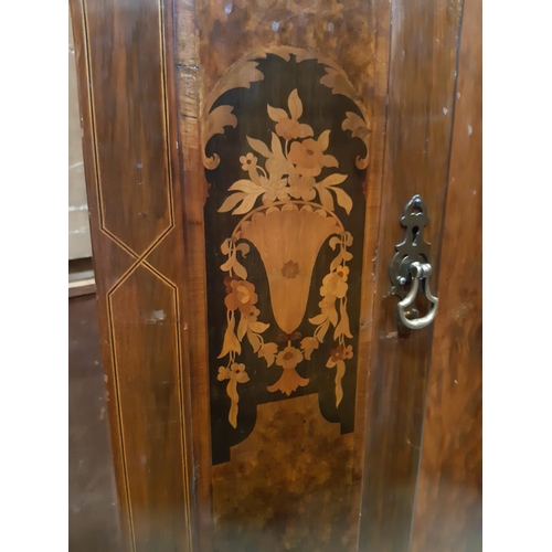 2177 - A 1920s walnut and figured walnut wardrobe with floral marquetry detail on short cabriole supports 1... 