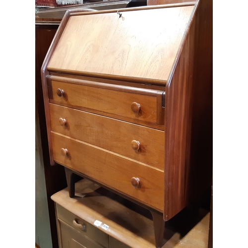 2178 - A mid 20th century teakwood bureau, fall flap over three long drawers on turned supports, together w... 