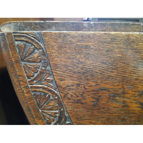 2185 - Late 19th century oak gateleg dining table on turned supports, the carved borders with repeating geo... 