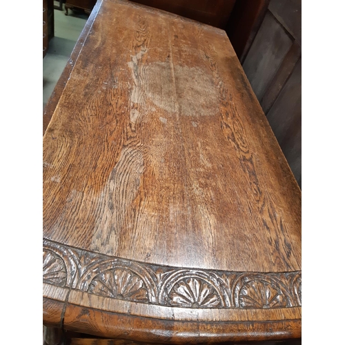 2185 - Late 19th century oak gateleg dining table on turned supports, the carved borders with repeating geo... 