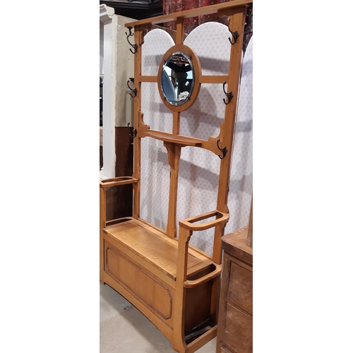 2190 - A simple oak hallstand, the central mirror panel over a box seat