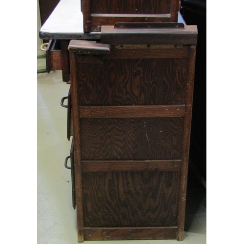 2194 - A vintage Hygena oak kitchen cabinet of full height enclosed by a series of drawers and cupboards an... 