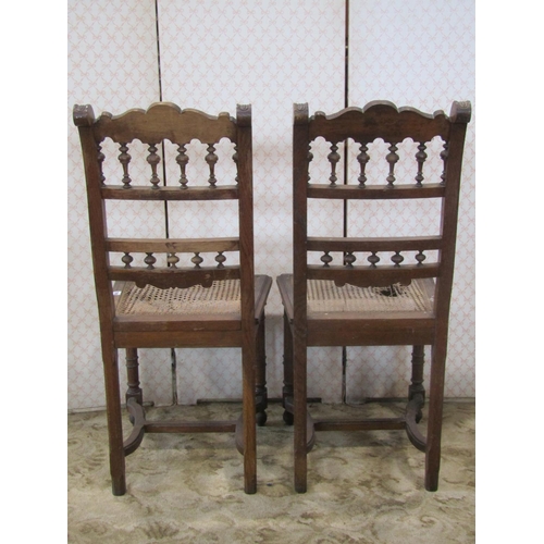 2198 - A set of six 19th century Breton oak dining chairs with turned spindle mouldings and cane panelled s... 