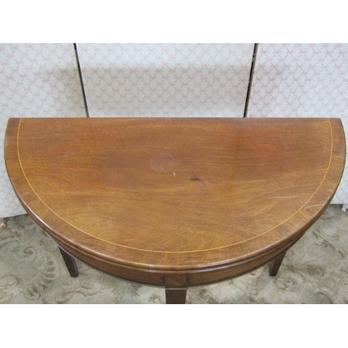 2200 - A reproduction Georgian style demi-lune fold over top card table on square taper legs