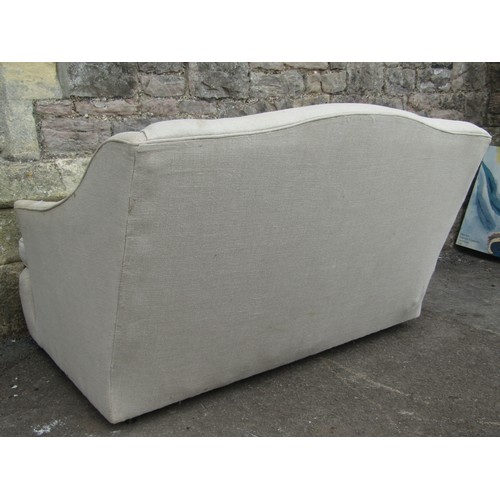 2205 - A small cottage two seat sofa upholstered in linen - for reupholstery, 130 cm wide