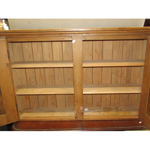 2206 - A stripped and waxed pine wall mounted hanging cupboard with shelved interior, 122 cm wide x 76 cm h... 