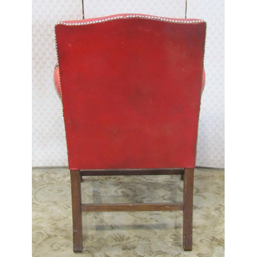 2220 - A Georgian style mahogany open armchair with red upholstered leather panels on moulded supports