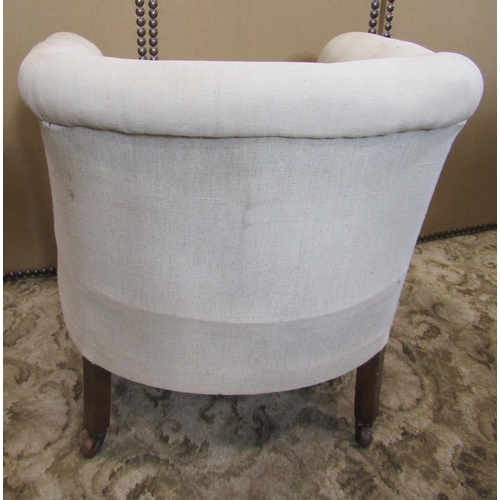 2221 - An Edwardian tub chair with simple upholstered finish, low rolled back and arms, raised on oak showw... 